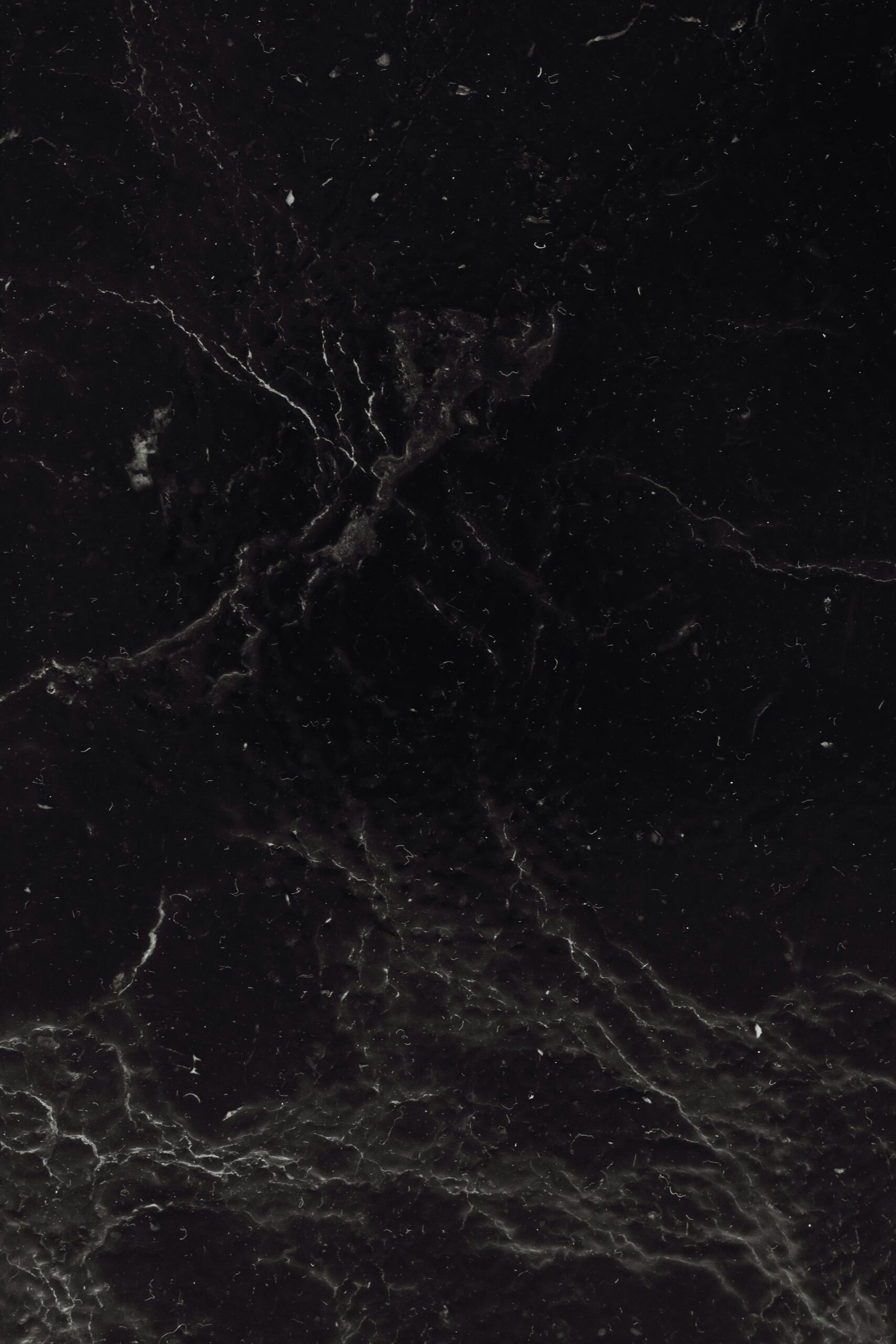 High-resolution image of intricate black marble texture showcasing natural patterns and details.